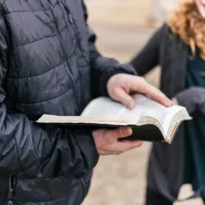 Someone holding an open Bible