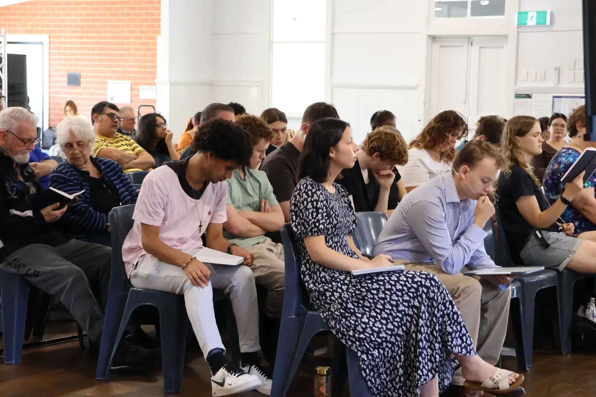 The congregation following along in their Bibles during a Sunday service at Clyde Public Hall